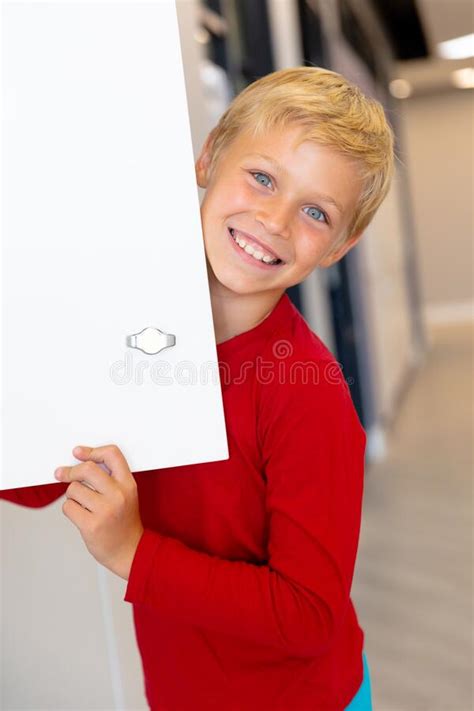 Close Up Portrait Of Smiling Caucasian Elementary Schoolboy Holding