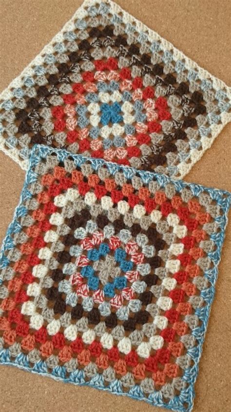 Two Crocheted Squares Sitting On Top Of A Table