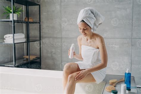 Young Woman Is Bathing In Morning At Home And Applying Body Lotion To