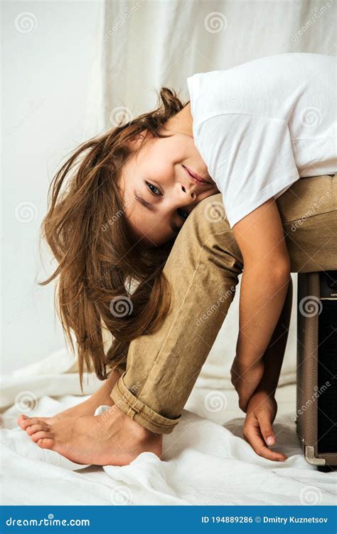 Little Girl Sitting Lying On Her Legs Hair And Arms Hanging Stock