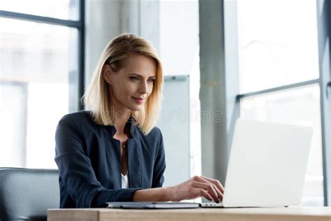 Smiling Professional Businesswoman Working With Laptop Stock Image