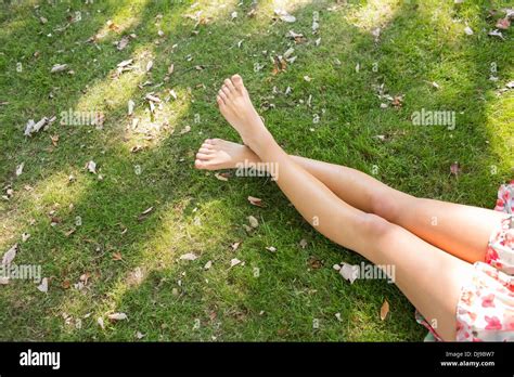 Close Up Of Female Crossed Legs Lying On The Grass Stock Photo Alamy