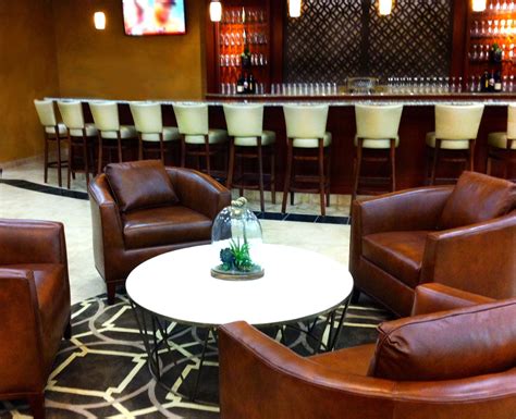 Bar Area With Custom Rug Lounge Seating Barstools Table And Floral