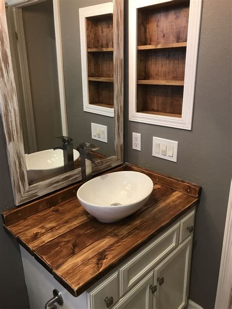 A Bathroom With A Wooden Counter Top Next To A White Sink And Large