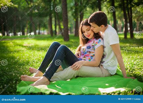 Young Lovers Out In The Park Lying On The Grass Stock Image Image Of