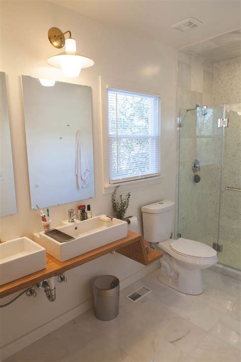 A Bathroom With Two Sinks A Toilet And A Stand Up Shower Stall In It