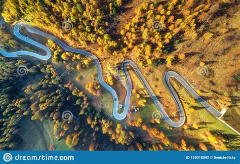 Winding Road In Autumn Forest At Sunset In Mountains Aerial View Stock