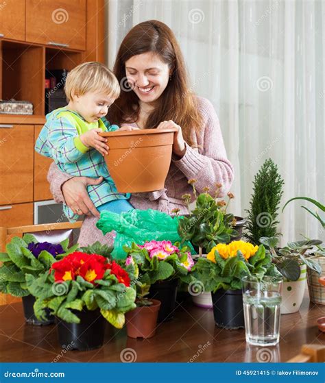 Mother And Baby With Flowering Plants Stock Image Image Of Girl