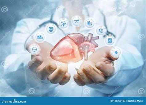 Doctor Cardiologist Hands With Flying Heart Cardiology And Heart Disease Concept Stock