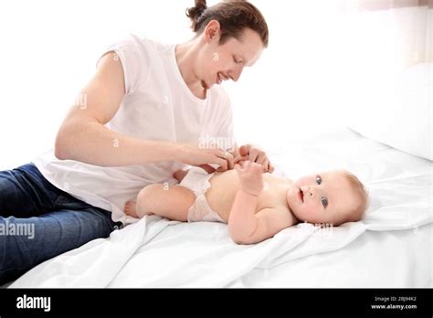 Father Changing Diaper To His Son Stock Photo Alamy