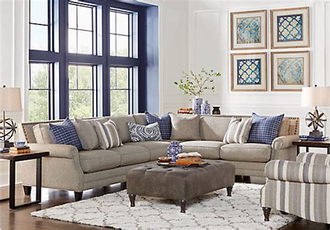 Ultra modern living room features metal framed sectional with white cushions and glass shelving over grey wood flooring, centered around innovative wood and metal coffee table. $2,949.99 - Piedmont Gray 6 Pc Sectional Living Room ...