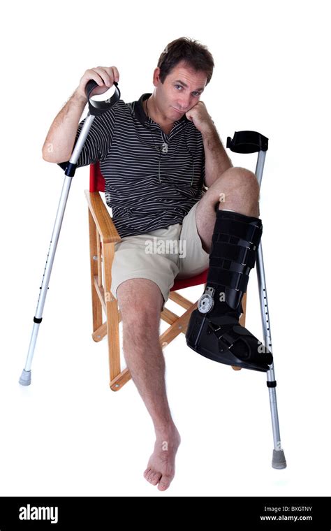 Mature Man With Broken Legs With Crutches And Showing A Boring