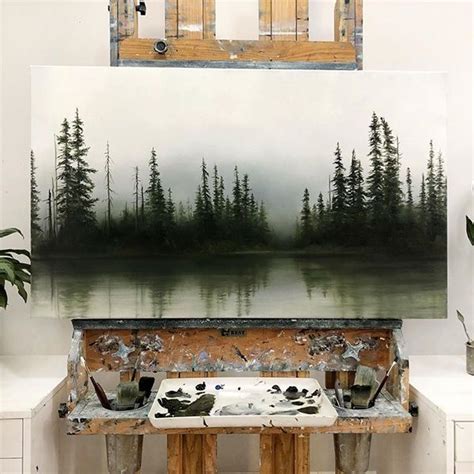 An Artists Easel With Paint And Brushes On It In Front Of A Painting