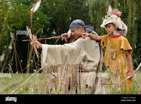 Native American Indian Man With A Bow And Arrow Hunting With A Boy