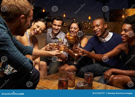 Group Of Friends Enjoying Night Out At Rooftop Bar Stock Image Image Of Party Ethnic 67525791