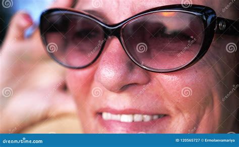 Close Up Shot Of Pretty Mature Woman In Aged Wearing Sunglasses Looks