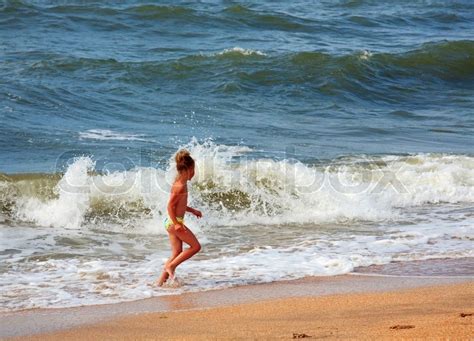 Small Girl Play On Beach With Stock Image Colourbox