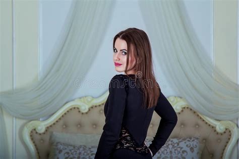 Portrait Of Beautiful Young Brunette Woman Standing In Bedroom Stock
