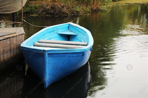 Light Blue Wooden Boat On Lake Near Pier Stock Photo Download On