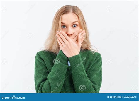 Scared Shocked Blonde Woman Covers Her Mouth With Her Hands And Wide