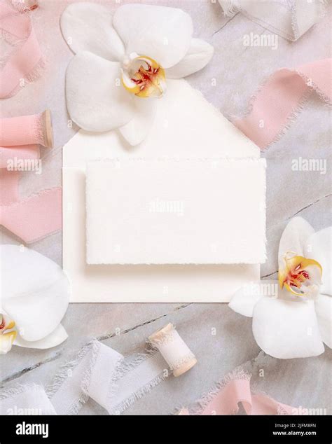 Wedding Horizontal Card And Envelope Near White Orchid Flowers And Silk