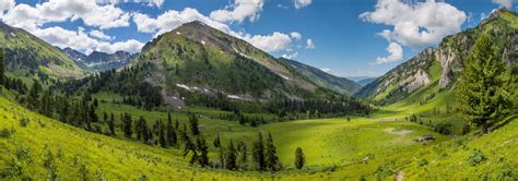 Beautiful Mountain Valley Snow And Greens On The Slopes Spring In The