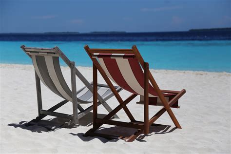 Two Folding Chairs On White Sand Seashore · Free Stock Photo