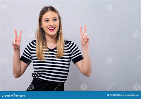 Young Woman Giving The Peace Sign Stock Photo Image Of Smile