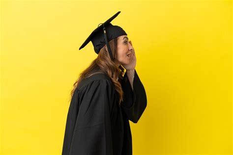 Premium Photo Middle Aged University Graduate Isolated On Yellow