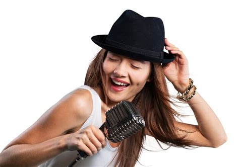 Premium Photo Young Woman Wearing Hat Singing Into Microphone