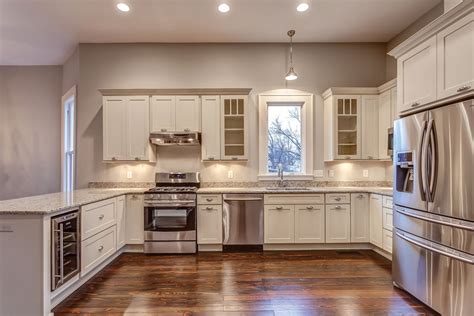 Providing a neutral backdrop, white kitchen cabinets can be left alone or dressed up with colorful art and accessories. White Shaker Cabinets - Kitchen Photo Gallery