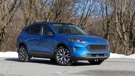 Includes premium sedan key features and adds 2020 Ford Escape SE Sport Hybrid Drivers' Notes | Photos ...