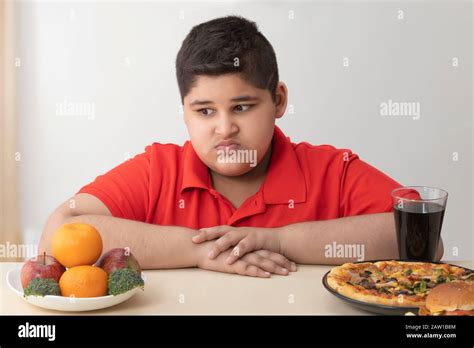 Young Boy Looking Disgustingly At Fruits And Vegetables Obesity Stock