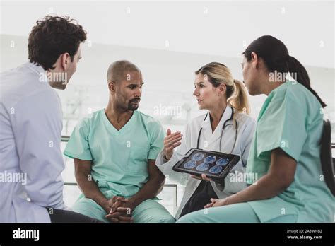 Medical Professionals Discussing Patient Treatment In A Hospital Stock
