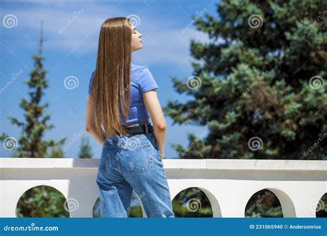 Back View Beautiful Brunette Girl In Blue Jeans Summer Park Outdoor