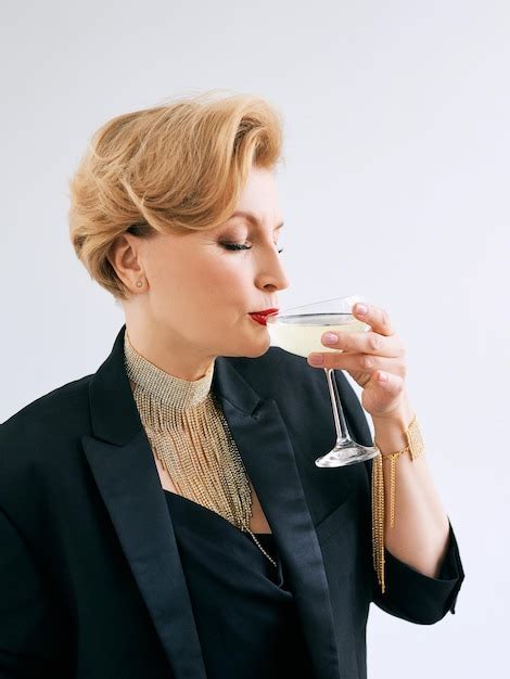 Premium Photo Mature Stylish Elegant Woman In Tuxedo With Glass Of Sparkling Wine