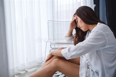 A Sad And Stressed Young Woman Sitting Alone In Bedroom Stock Image