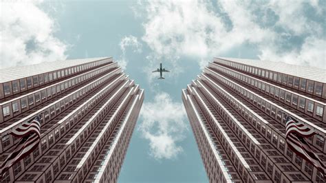 Worms Eye View Photo Of Plane Between Two High Rise