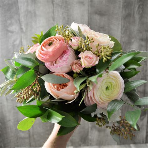 how gorgeous is this bouquet of ranunculus and seeded eucalyptus send flowers fresh flowers