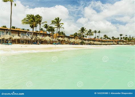 Beautiful View Of White Sand Aruba Beach Blue Sunbeds Under Sun