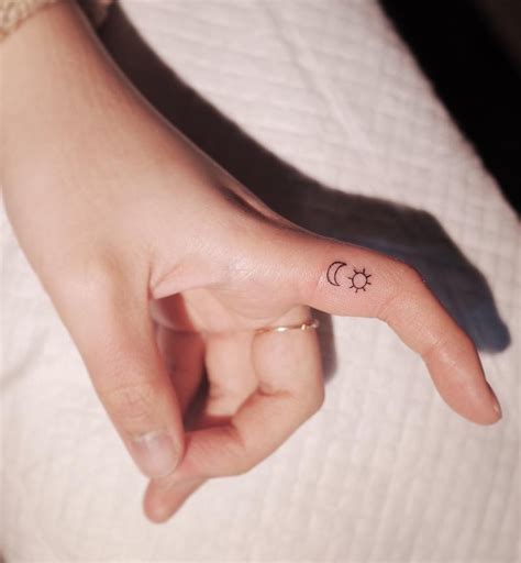 sun and moon finger tattoo by witty button tattoo insider