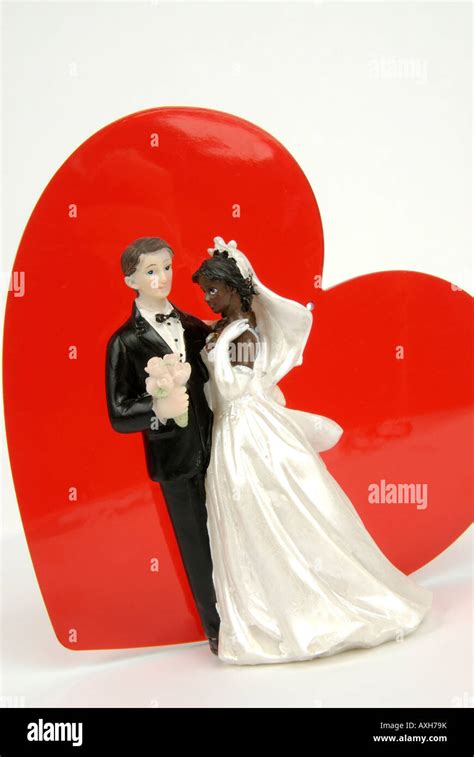 bridal couple figurines and red heart symbolic image mixed nationality mixed race marriage