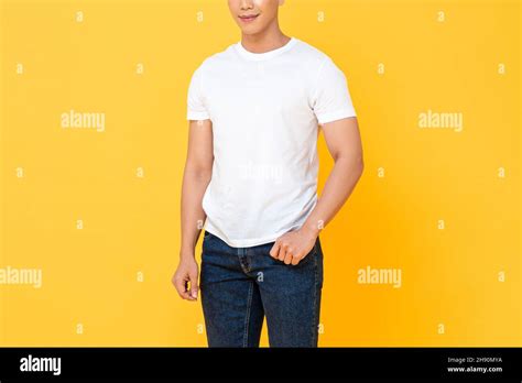 Young Man Wearing White T Shirt And Blue Jeans In Yellow Color Isolated