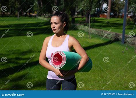 Young Woman With Fitness Mat In The Hands Looking Away And Ready For