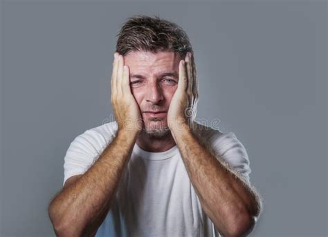 Portrait Of Sad And Depressed Man With Hands On Face Looking Desperate