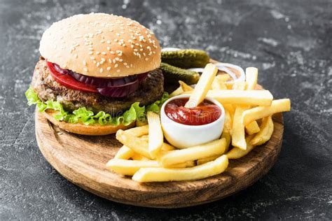 Beef Burger With Lettuce And Tomato Potato Fries And Ketchup Stock