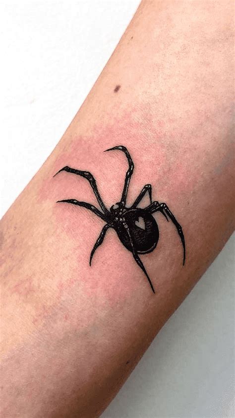 A Black Spider Tattoo On The Arm