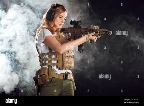Girl Marksman In Sniper Gear Holding Sniper Rifle In Hand Aiming At