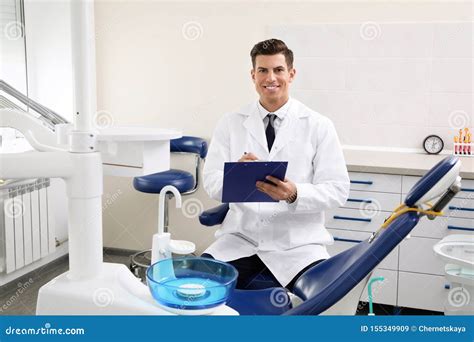 Portrait Of Professional Male Dentist With Clipboard Stock Image