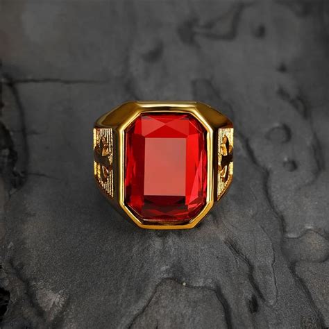 A Red Stone Ring Sitting On Top Of A Rock